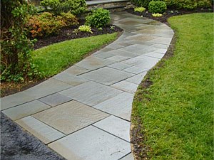 Cut bluestone walkway replaces a plain concrete walk